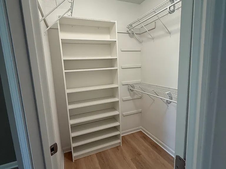 Primary bedroom walk-in closet.