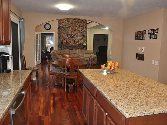 kitchen connected to two story family room with pond view