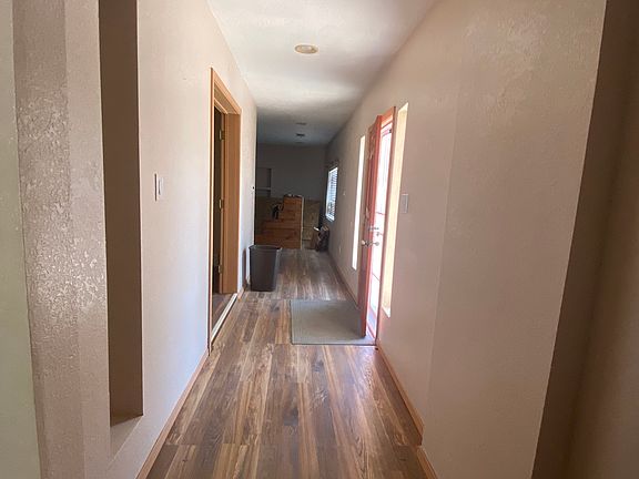 Entry way. Hallway to the right leads to large family room. Hallway to the left leads to bedrooms and second living area. Directly in front of entry door is the study/office.