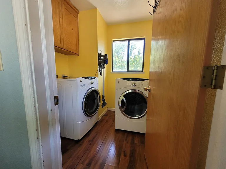 Laundry room is now whote and comes with a washer and dryer.