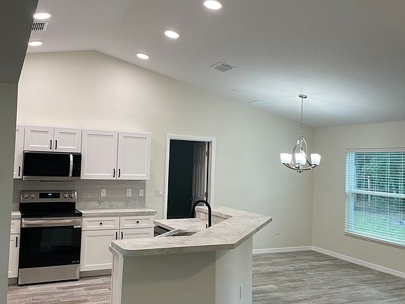 Partial view of kitchen and breakfast area