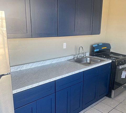 Updated Kitchen with brand new cabinets, sleek countertops, and stainless steel appliances.
