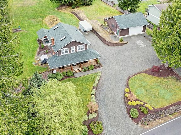 Here you see the circular driveway, home and detached garage with shop. 