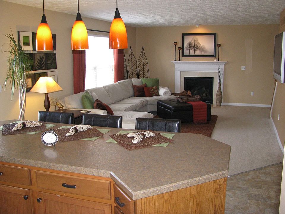 Freestanding island in open floor plan connecting kitchen and living room.