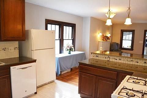 Part of kitchen looking into dinette and living room