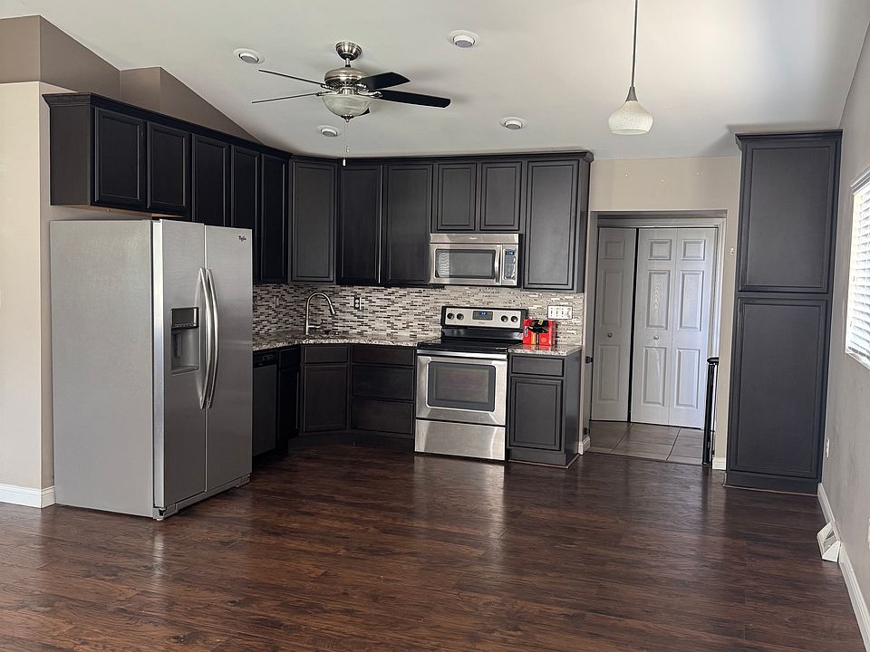 Open Kitchen, Dining Area, and Living Room with vaulted ceilings and modern kitchen.