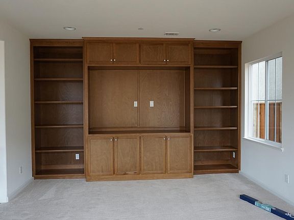 Custom media wall with bookshelves