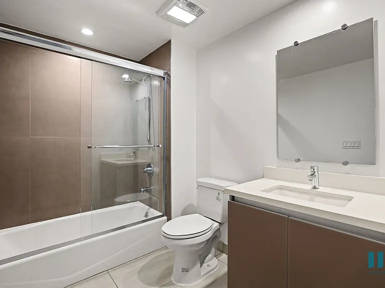 Bathroom with Shower Bath with Glass Door and Vanity Cabinet Storage