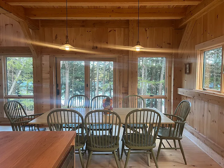 Looking from the island and sink toward the dining area and the water.