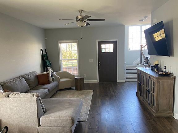 Front door entry into living area - L-couch and 70" smart TV