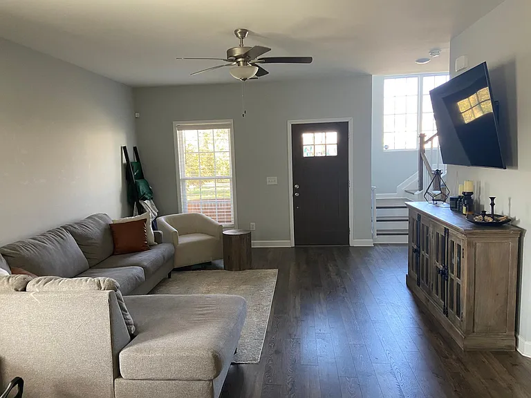 Front door entry into living area - L-couch and 70" smart TV