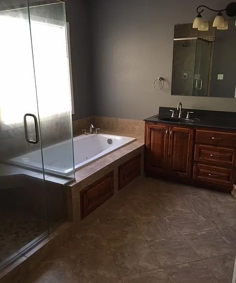 Master bathroom with two sinks, & walk in closet. Tile floor