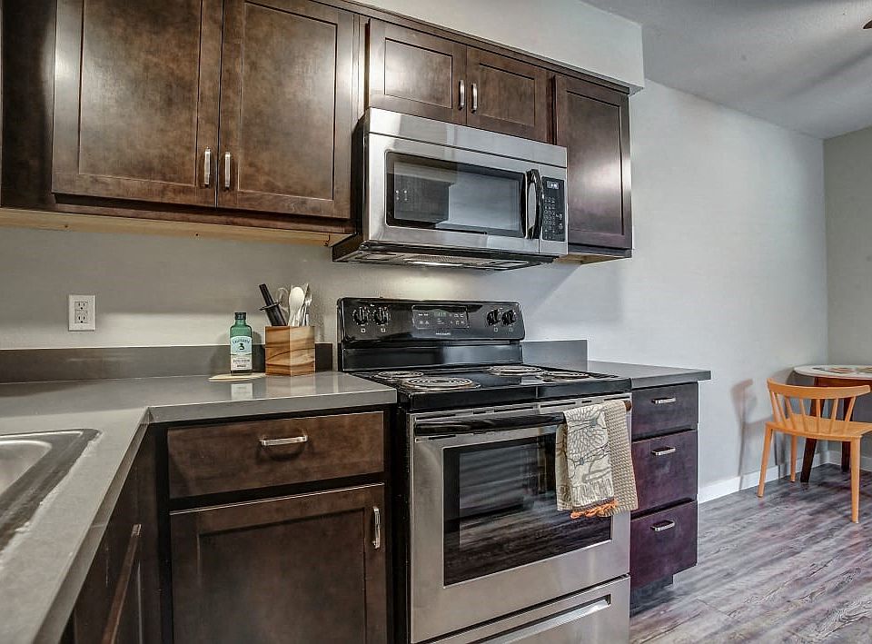 Full-sized kitchens with updated hardware and lighting.