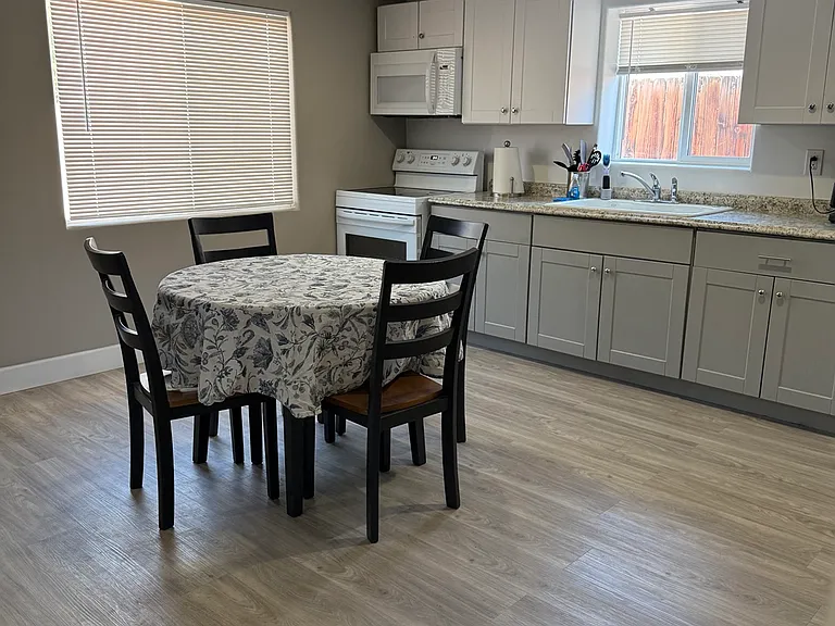 Bright open-concept living and kitchen area with modern finishes and comfortable dining space