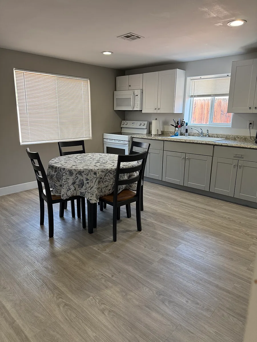 Photo 2 of 17 - 1122 S 10th St #1 - Las Vegas, NV Bright open-concept living and kitchen area with modern finishes and comfortable dining space - 1122 S 10th St #1