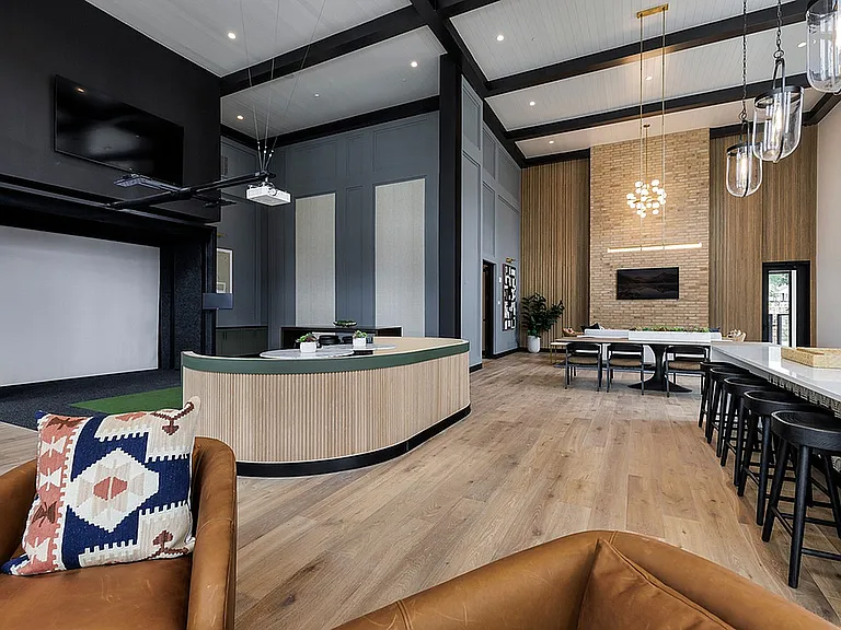 Elegant and spacious communal area with high ceilings, modern seating.