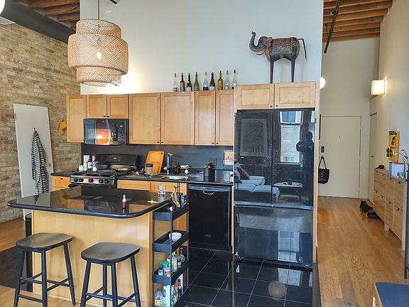 bedroom is closed off from the living room and kitchen