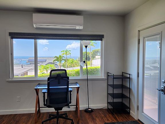 Desk and office chair. Split AC unit to keep you cool.