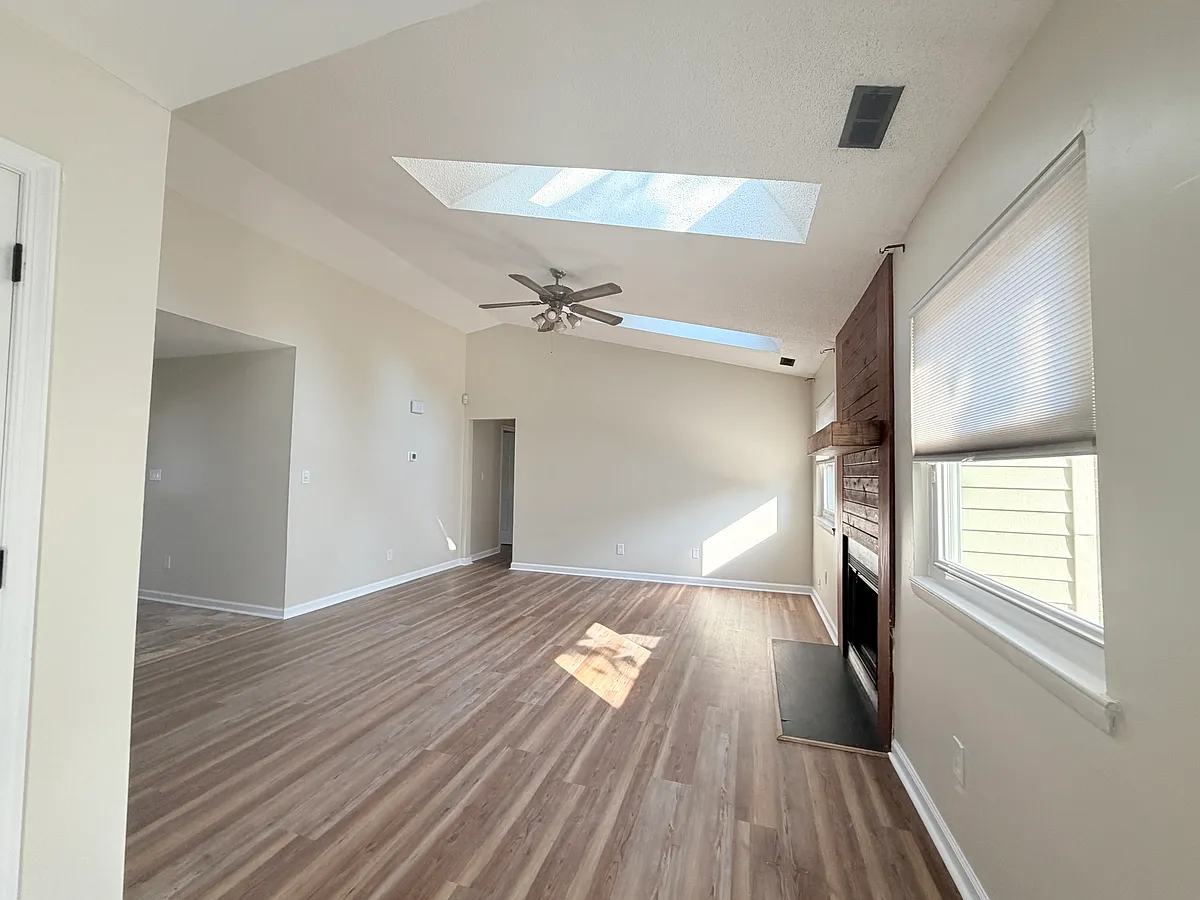 From kitchen bar area--the living are with new Sentimental beige wall color - 1801 Saint Regis Cir