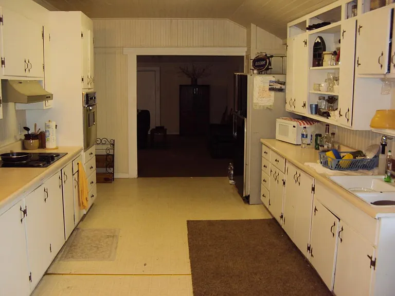 Upper kitchen with living room view.