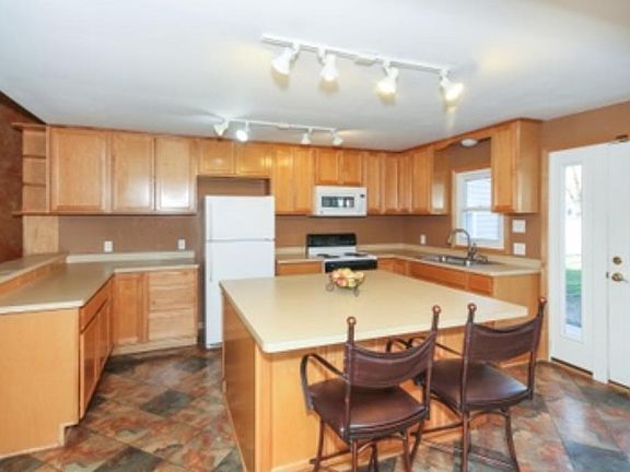 This amazing kitchen is 16x14 remodeled in 2004 with Maple cabinets, large center island and many cabinets. Patio doors off to the largest cement patio! Enjoy the evening sunsets and dinner on this 57x13 and wraps around to another 26x13.