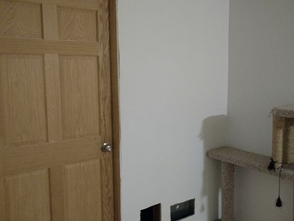 To the left of front door