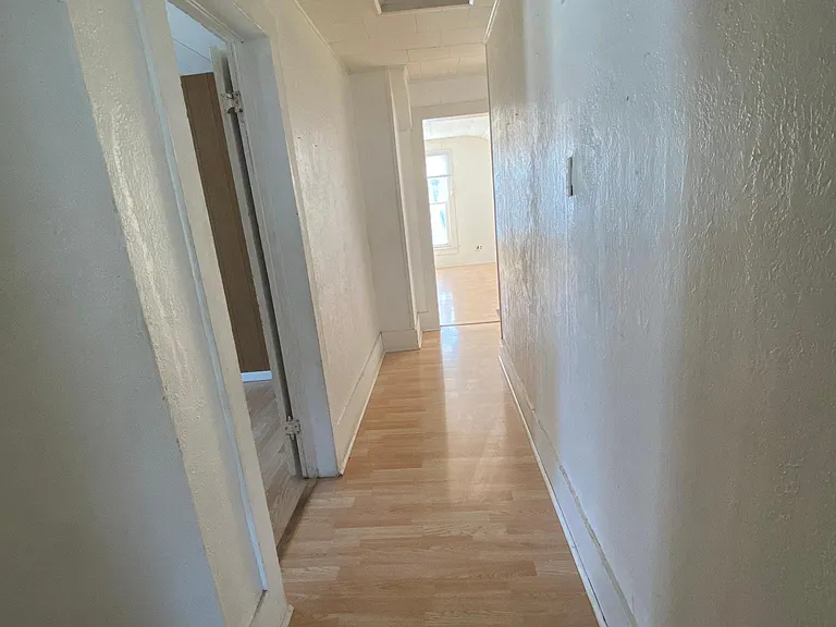 hallway w/bedroom to left, living room at en