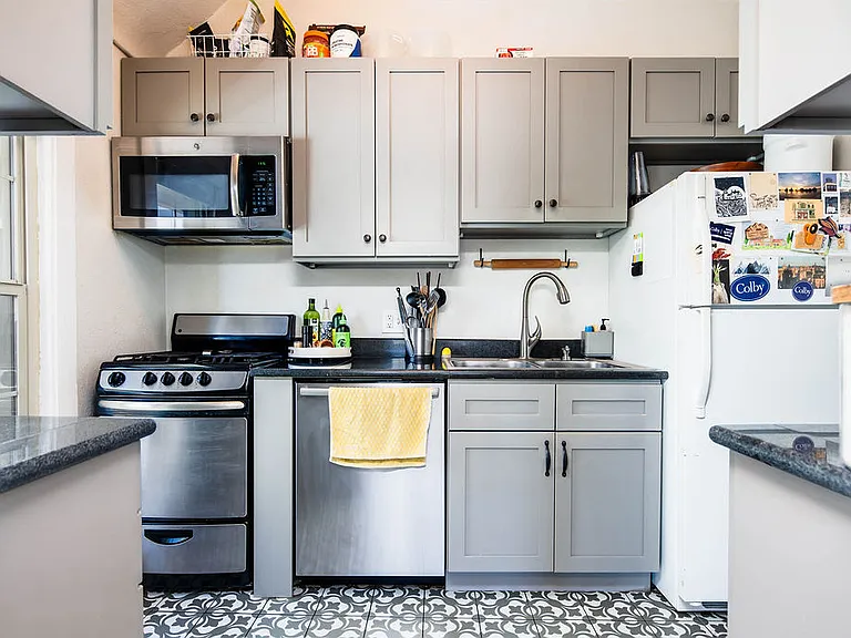 Remodeled kitchen with gas range, dishwasher, and microwave