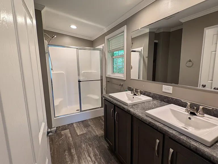 master bath with window, exhaust fan, linen closet, and extra storage to left of shower.