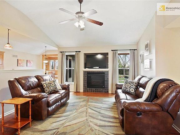 Open floor plan with great room leading into eat-in kitchen.  This room features wood floors, vaulted ceilings, gas-log fireplace.
