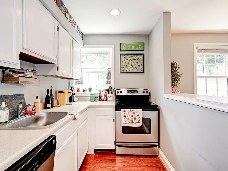 White wood cabinetry & pass-thru to dining room