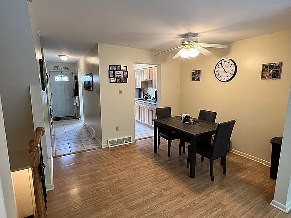 Dining Room with kitchen and entry hallway in the background