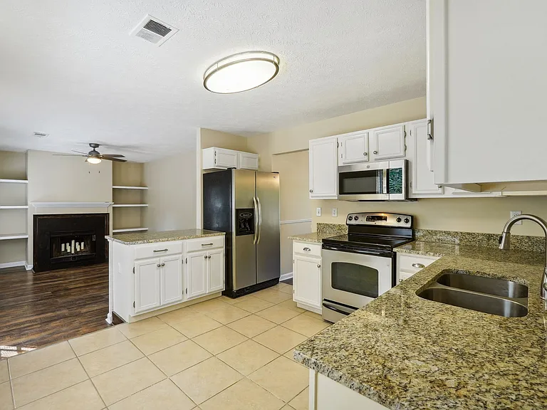 Kitchen with tiled floor and stainless appliances