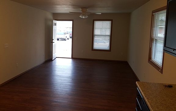 Large living room area with easy-to-clean vinyl plank flooring.