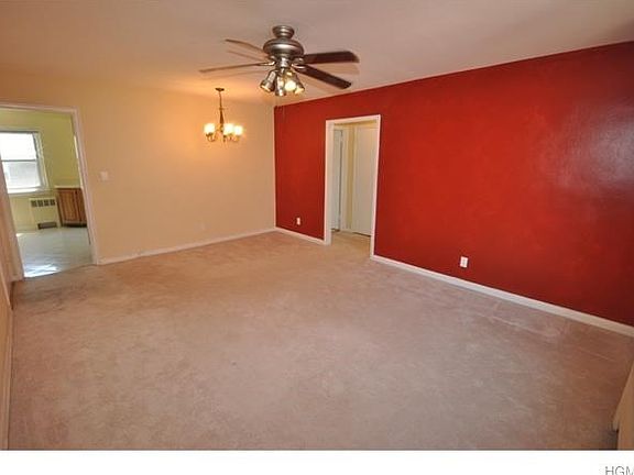 Bright large living room with wall to wall carpet and large walk-in closet.