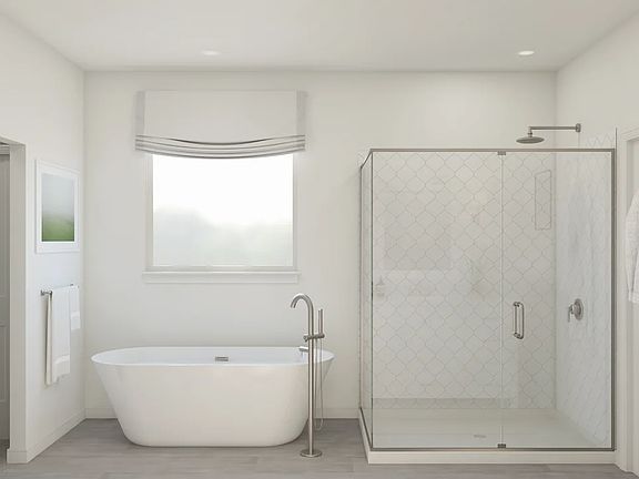 Primary bath with freestanding tub and glass shower enclosure