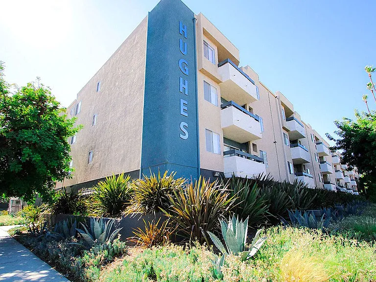 Exterior front of building showing landscaping and freshly painted building colors.