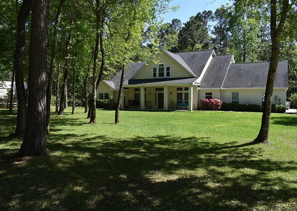 Beautiful 1.5 story home nestled on a spacious 1 acre lot with plenty of trees to provide privacy.