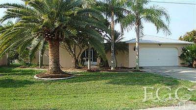 Front of Home with Pineapple Palm Tree 