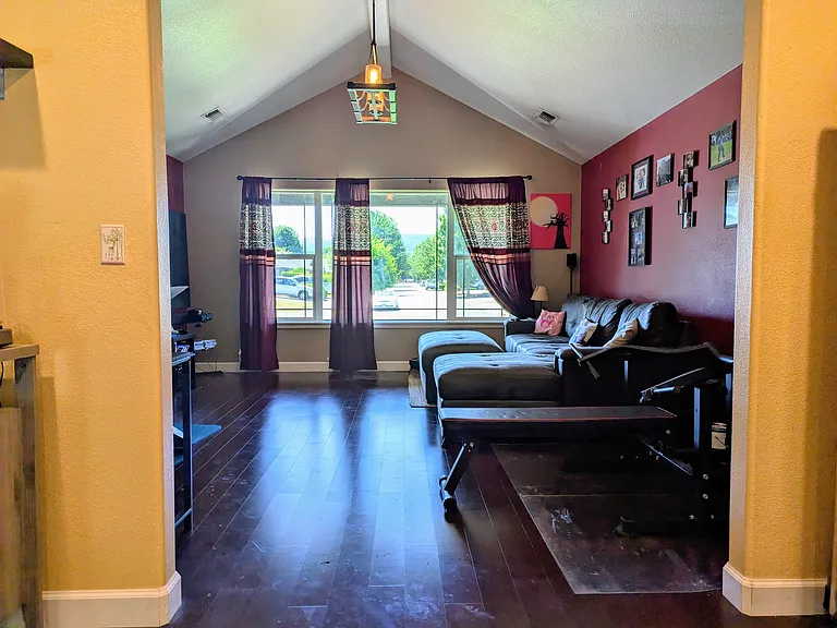 Vaulted ceiling and view of Jacksonville hills