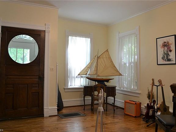 Note the gorgeous round beveled glass and heavy wood front door and the large foyer.  The current owners use it as a music room and art/sculpture galley
