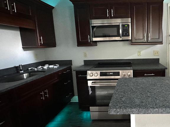 LR walkthrough to kitchen with mood lights on.