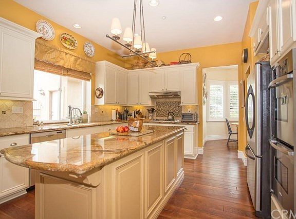 Kitchen overlooks the enchanting backyard and has a formal breakfast room adjacent.