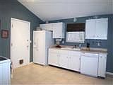 Clean kitchen with ceramic tile floors and new countertops installed in '08