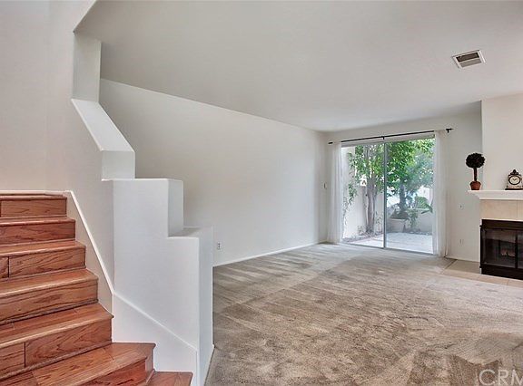 Neutral carpet in the living room and beautiful hardwood flooring