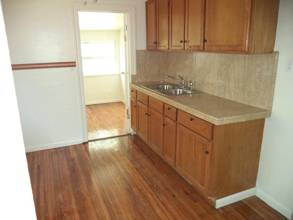 New kitchen with solid wood cabineys and porcelain tile coun