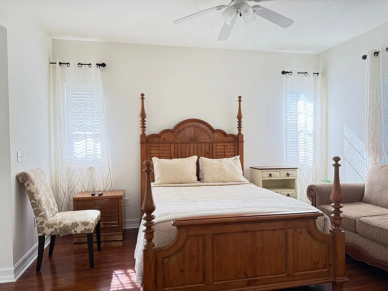 Main Queen bedroom, couch is part of living room until patio furniture is placed back on patio .