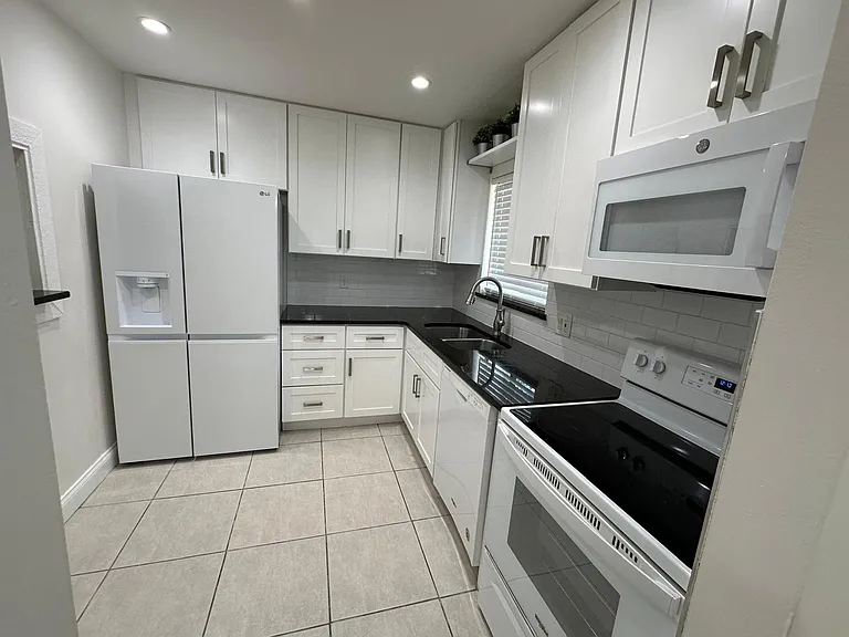 KITCHEN,
REMODELED WITH ALL APPLIANCES. REFRIGERATOR, MICROWAVE, RANGE AND DISHWASHER.