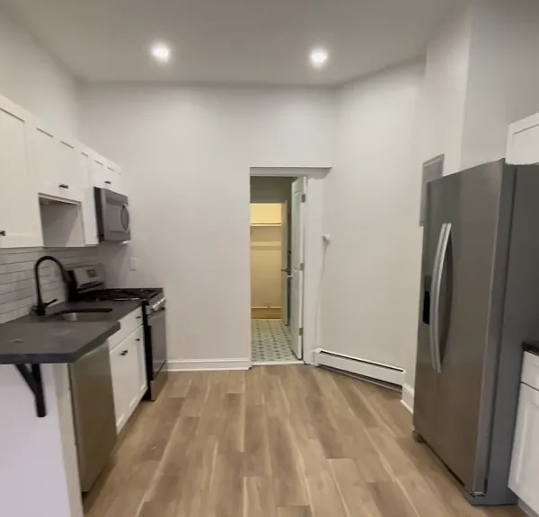 Kitchen looking into bathroom and walk in closet