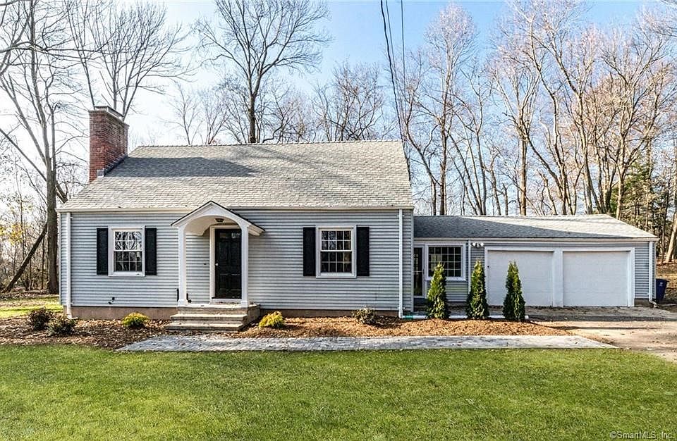Exterior front picture of 502 Ferry Rd. Note the 2 car garage, new windows, and new brick front walk.